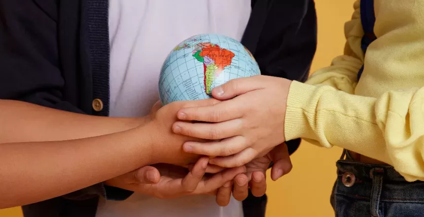 happy school friends holding earth globe jpg